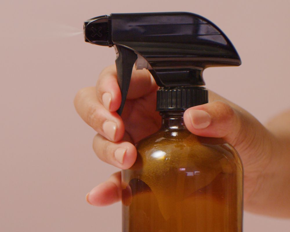Remove wet or dry oil-based spray paint using hairspray