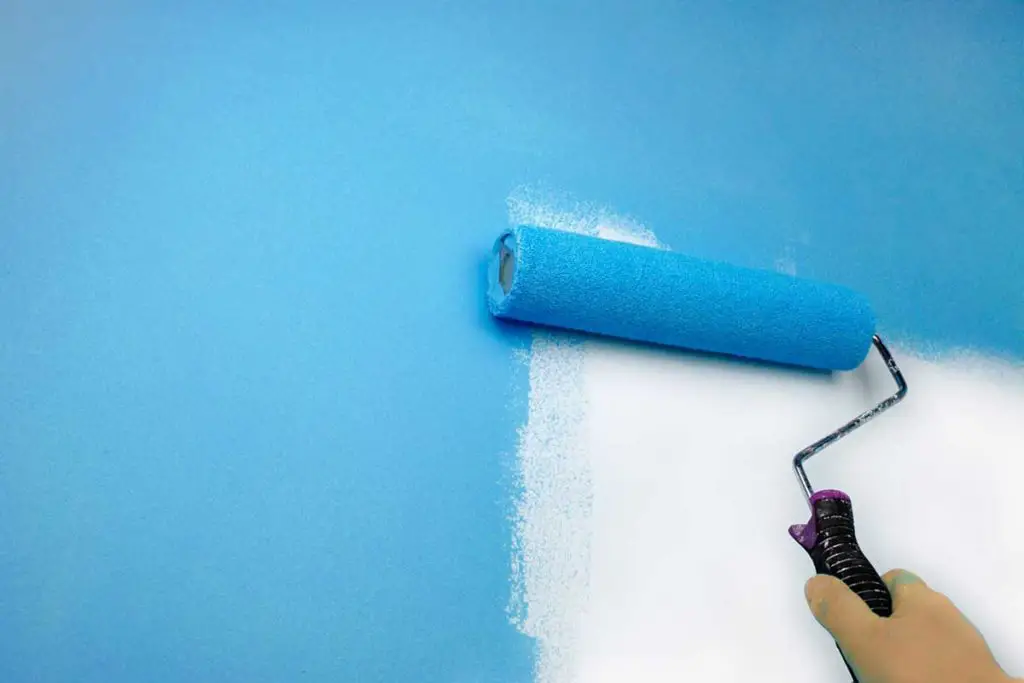 Apply paint to the wall with a roller