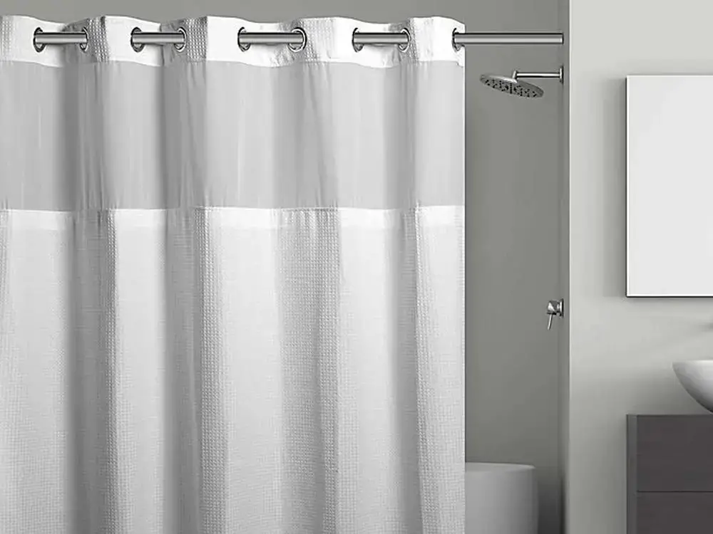 Place a water-resistant fabric shower curtain outside the shower