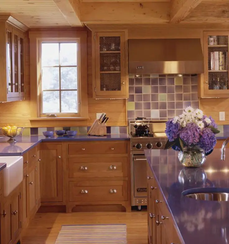 A purple backsplash for honey oak cabinets with bluish undertones